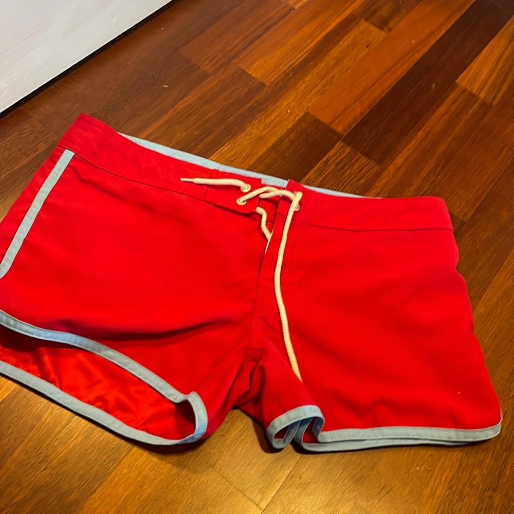 Red and light blue board shorts. Drawstring and Velcro middle. Super cute
